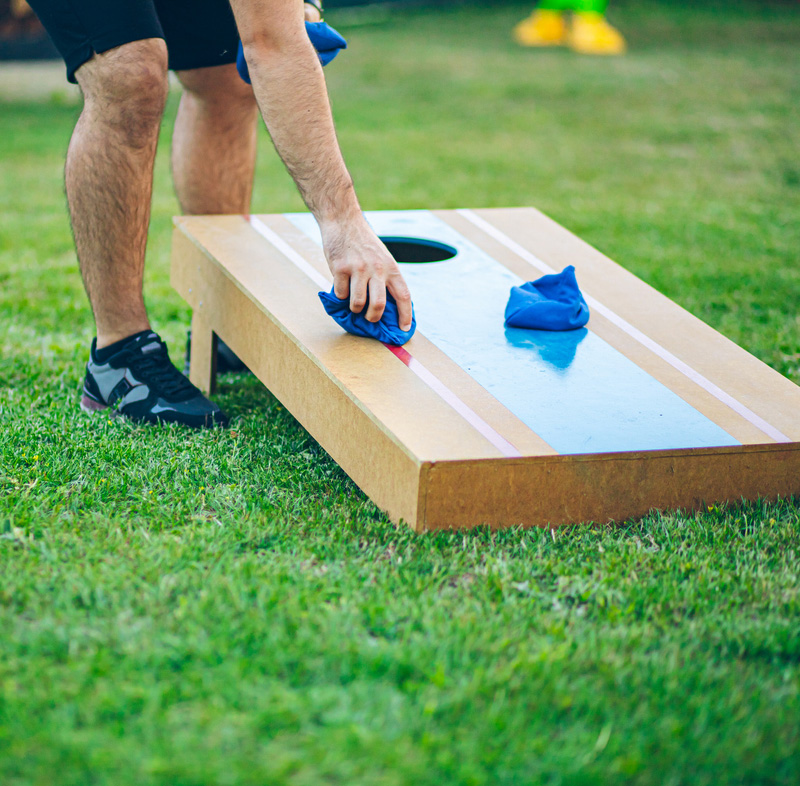 Playing bean bag toss in the backyard
